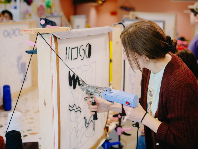 Woman tufting a DIY rug